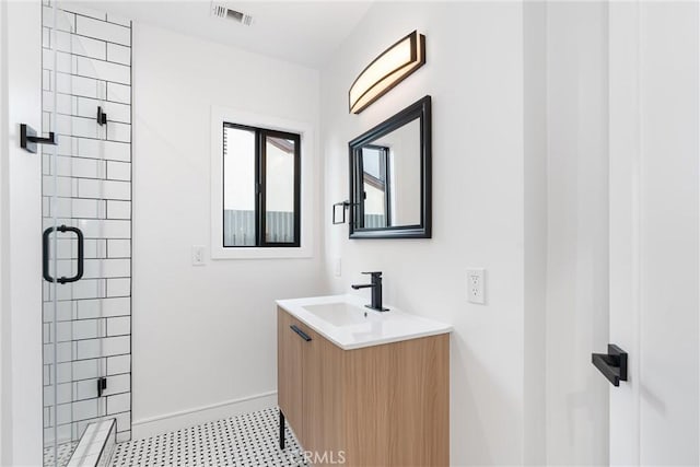 bathroom featuring vanity and a shower with door