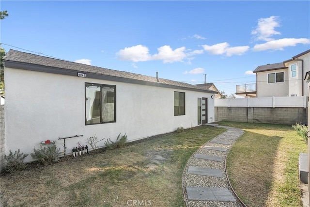 rear view of house featuring a lawn