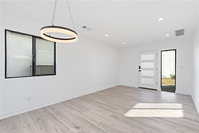 spare room featuring light hardwood / wood-style floors