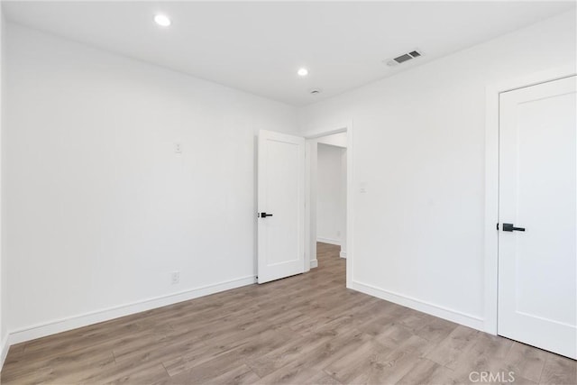 spare room featuring light hardwood / wood-style flooring