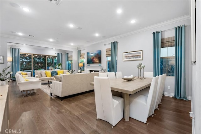 dining room featuring ornamental molding and dark hardwood / wood-style flooring