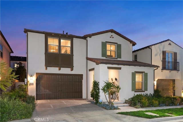 mediterranean / spanish-style house with a garage