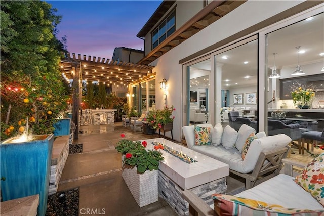 view of patio / terrace with an outdoor living space with a fire pit and a pergola