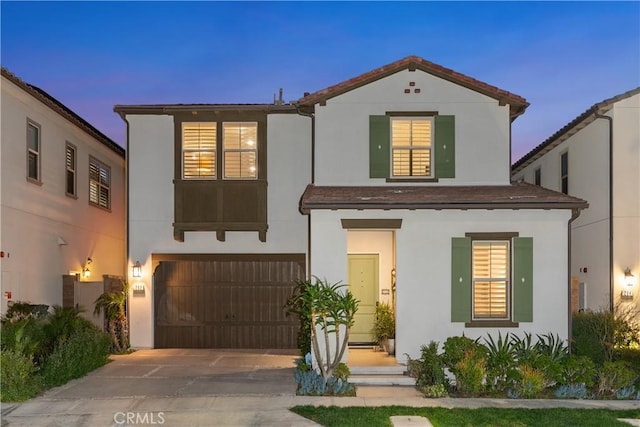 mediterranean / spanish-style house with a garage