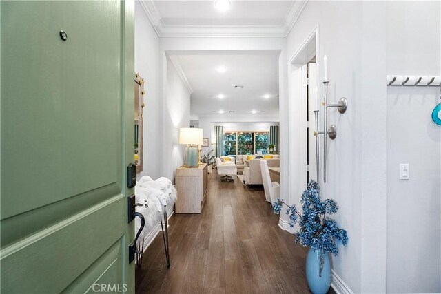 foyer with dark wood-type flooring and ornamental molding