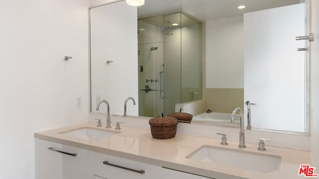 bathroom with vanity and independent shower and bath