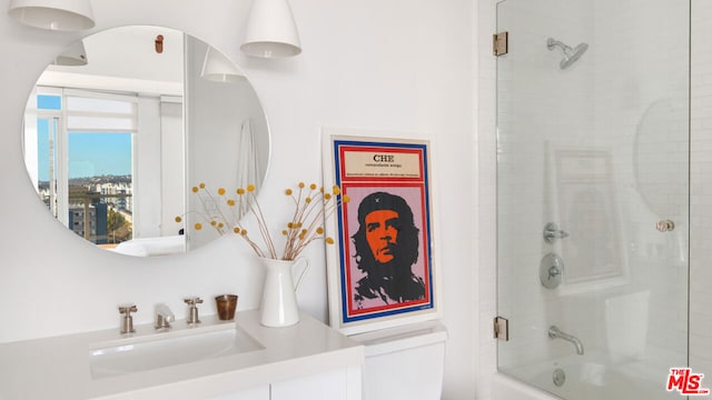 bathroom with combined bath / shower with glass door and sink