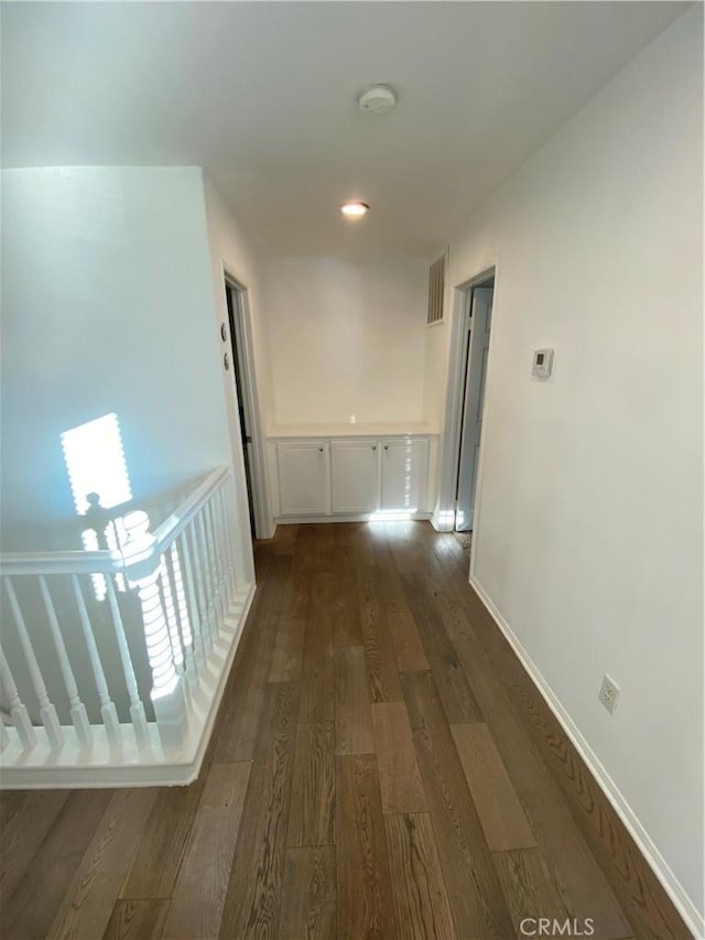 hallway featuring dark wood-type flooring