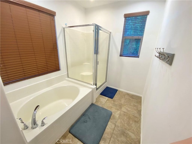 bathroom with tile patterned floors and shower with separate bathtub