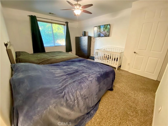 bedroom with ceiling fan and carpet