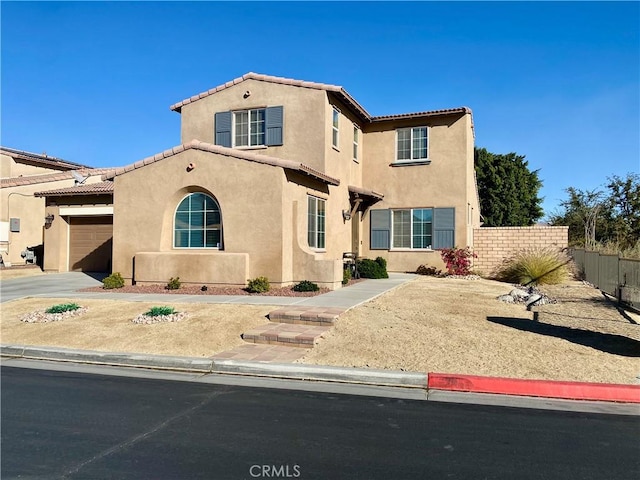 mediterranean / spanish-style home with a garage