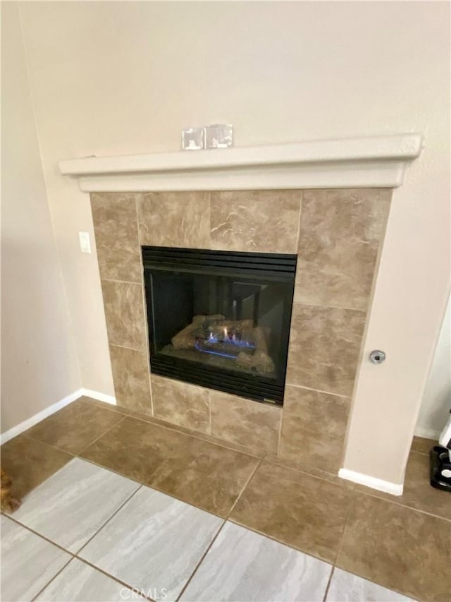 interior details featuring a tiled fireplace