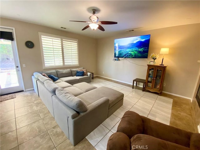 tiled living room with ceiling fan