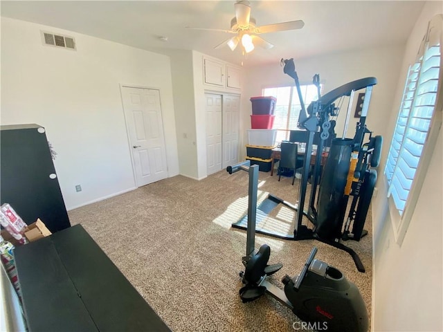 workout room with ceiling fan and carpet floors