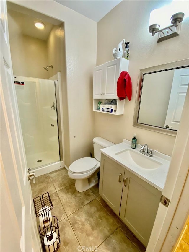 bathroom featuring vanity, toilet, tile patterned floors, and walk in shower