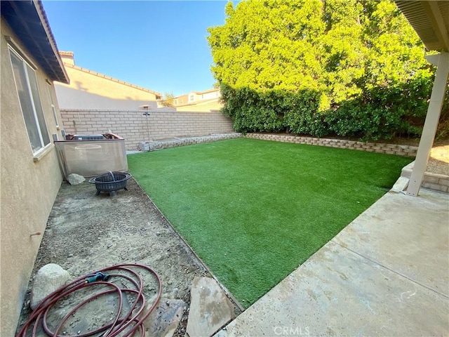 view of yard featuring an outdoor fire pit and a patio area