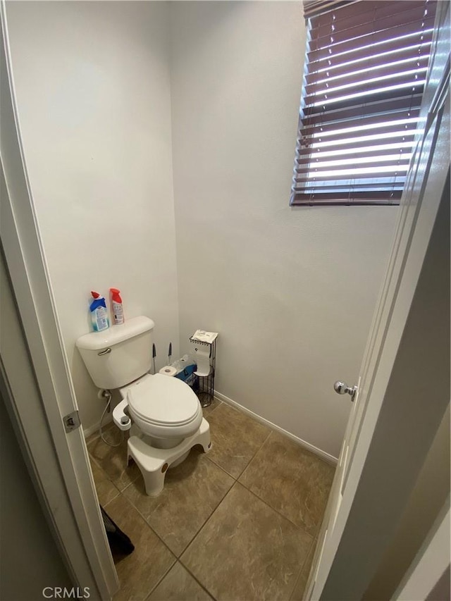 bathroom featuring tile patterned flooring and toilet