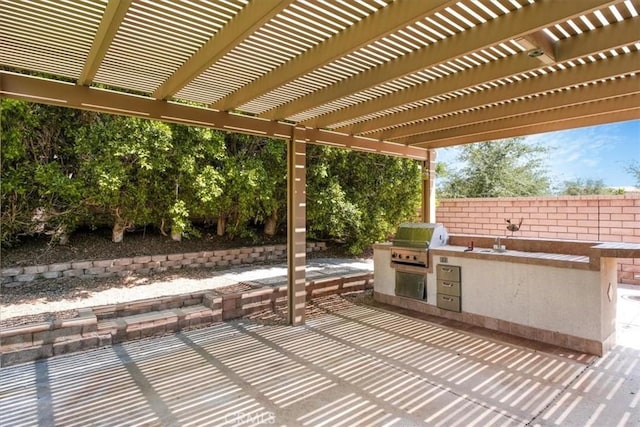 view of patio with a grill, exterior kitchen, and a pergola