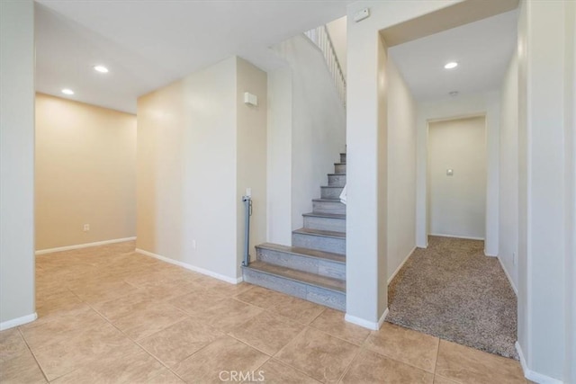 staircase with baseboards, tile patterned floors, and recessed lighting