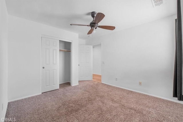 unfurnished bedroom with visible vents, a ceiling fan, a closet, baseboards, and light colored carpet