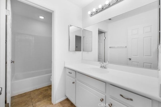 bathroom with tile patterned floors, toilet, shower / bathtub combination, baseboards, and vanity