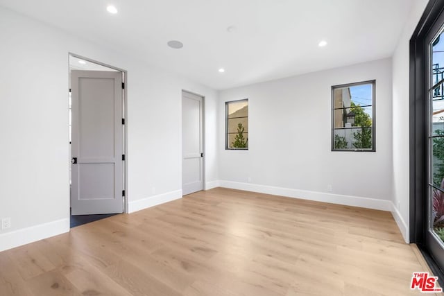 spare room with light wood-type flooring