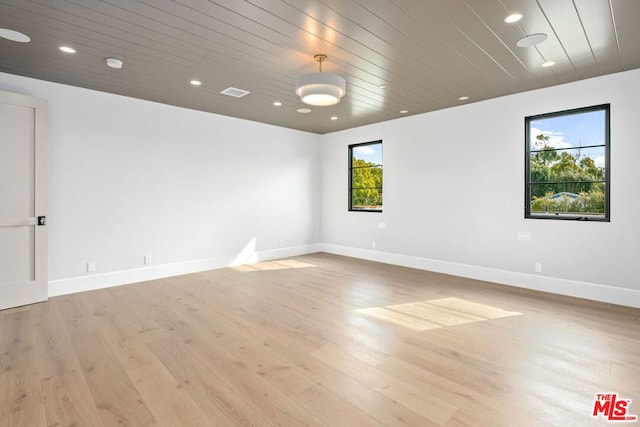 spare room with wood ceiling and light wood-type flooring