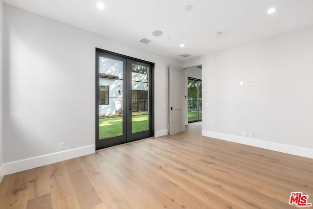 unfurnished room with light hardwood / wood-style flooring