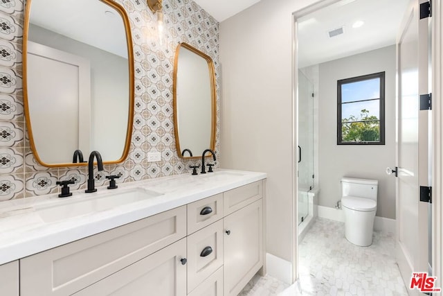 bathroom with vanity, an enclosed shower, and toilet