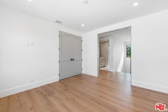 empty room with light hardwood / wood-style flooring