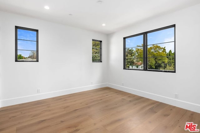 spare room featuring light wood-type flooring