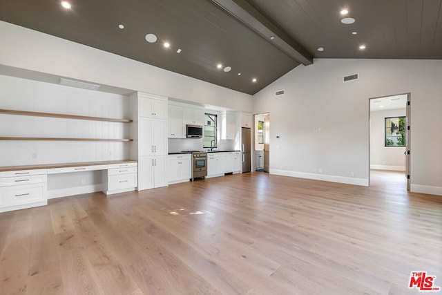 unfurnished living room featuring sink, built in desk, high vaulted ceiling, light hardwood / wood-style flooring, and beam ceiling