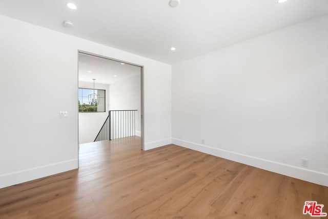 unfurnished room with wood-type flooring