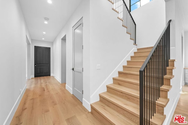 staircase featuring hardwood / wood-style floors