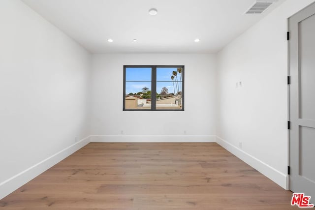 empty room with light hardwood / wood-style floors