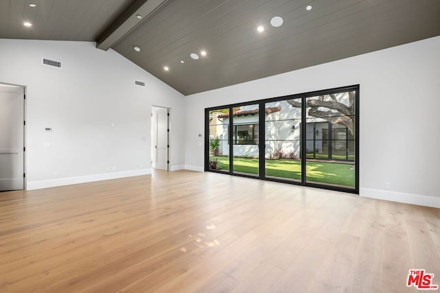 spare room with high vaulted ceiling, beam ceiling, and light hardwood / wood-style floors