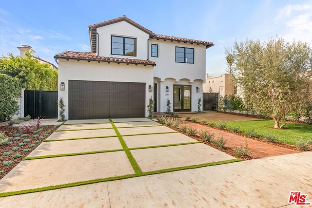 mediterranean / spanish-style home featuring a garage and a front lawn