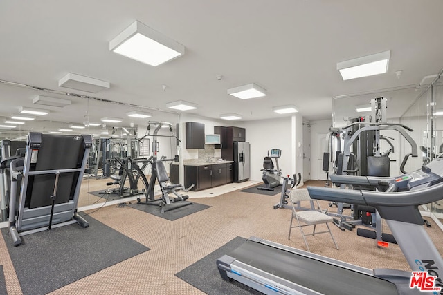 gym featuring light carpet