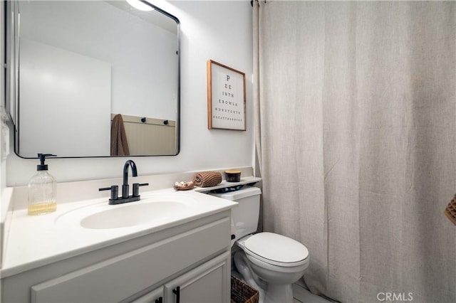 bathroom featuring vanity and toilet