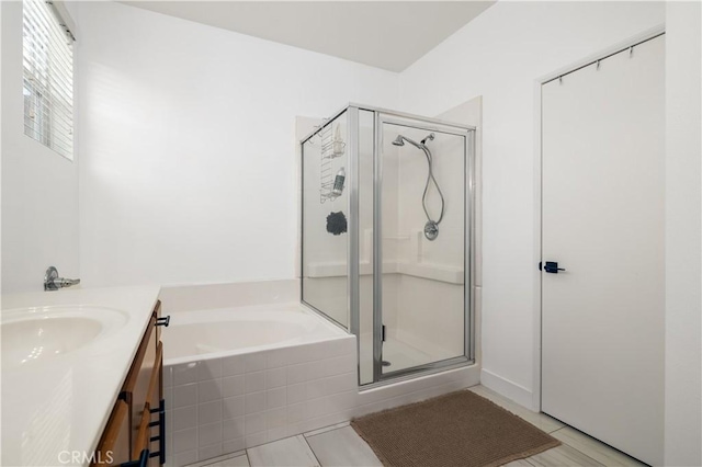 bathroom with vanity, tile patterned floors, and plus walk in shower