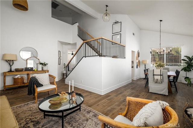 living room featuring dark wood-type flooring, high vaulted ceiling, and a chandelier