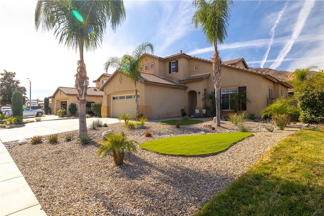 mediterranean / spanish-style home with a garage