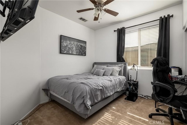 bedroom featuring ceiling fan, carpet flooring, and multiple windows