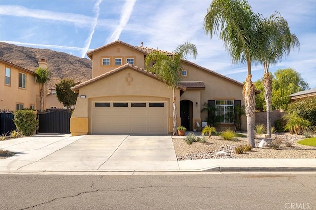 view of front of property featuring a garage and a mountain view