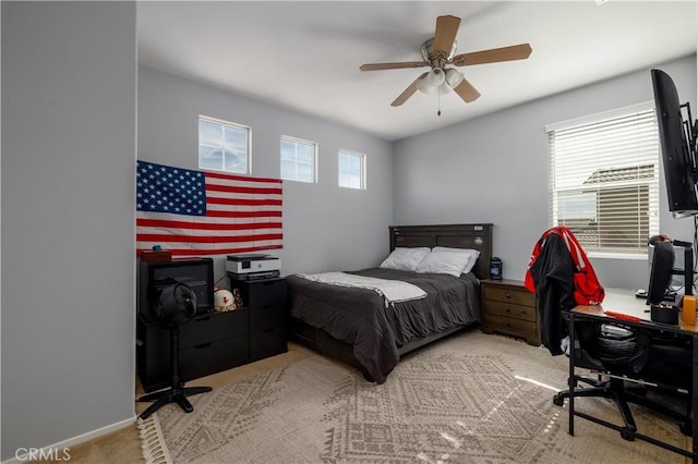 bedroom with light carpet and ceiling fan