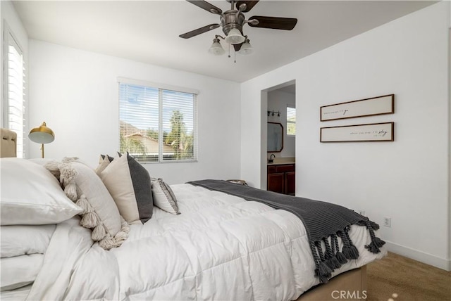 carpeted bedroom featuring ceiling fan and ensuite bathroom