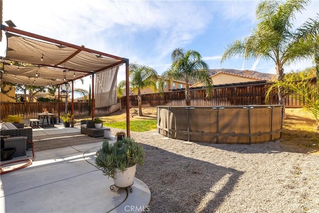 view of yard with a fenced in pool and a patio area