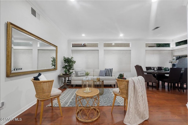 living room with ornamental molding and dark hardwood / wood-style floors