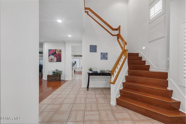 stairway with tile patterned flooring