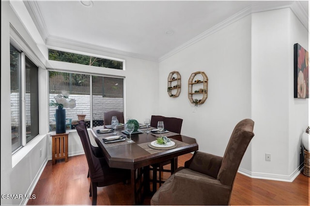 dining room featuring ornamental molding and hardwood / wood-style floors